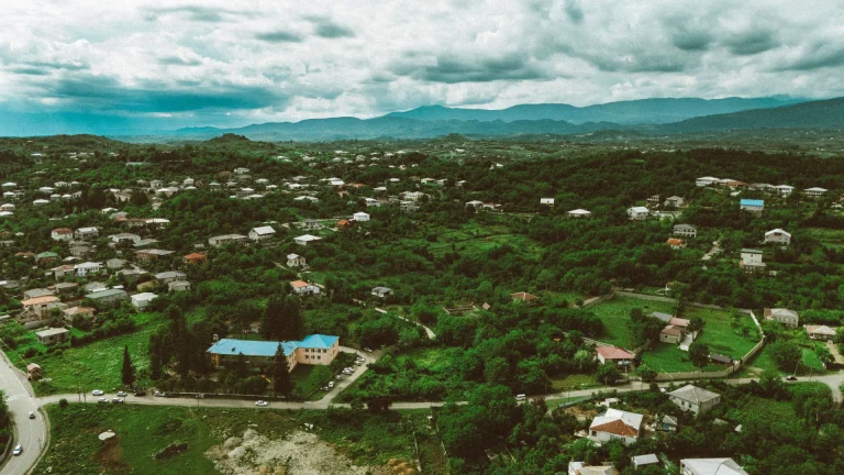 Breathtaking aerial view of Georgian rural landscape with lush greenery and distant mountains in spring