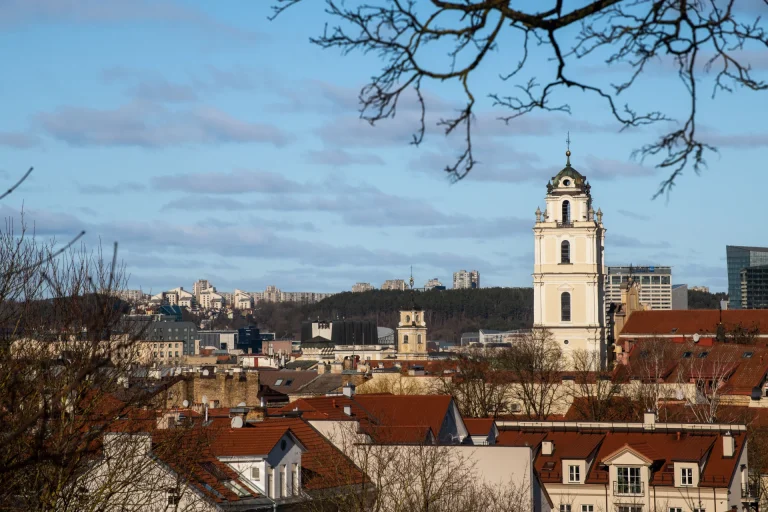 A beautiful view of Vilnius city featuring historic architecture and a prominent church tower under a clear sky