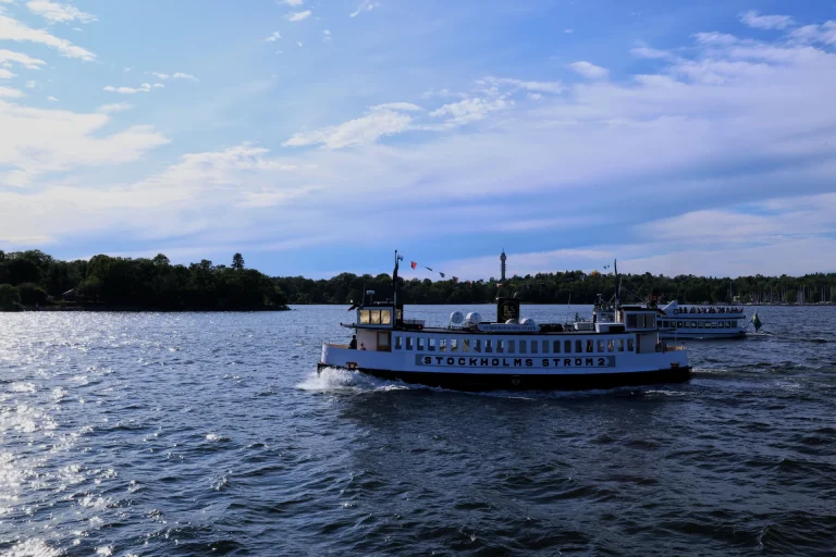 Enjoy a picturesque view of boats cruising on Stockholms Strom under blue skies