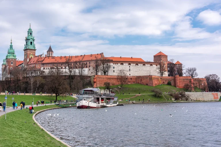 Scenic view of Wawel Castle with boats on the Vistula River Krakow Poland
