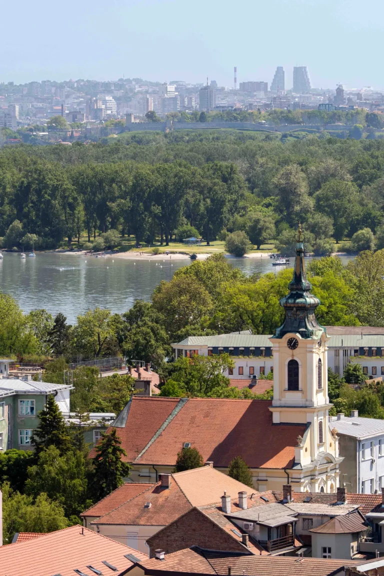 View of a church in Zemun with Danube River and Belgrade skyline in the background
